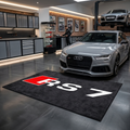 Audi RS7 garage floor mat, 5x7 ft (60x87"), bold red and white RS7 logo on black background with dimensions shown.