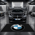 BMW garage floor mat, 5x7 ft (60x87"), iconic BMW roundel emblem in blue white and black on black background with dimensions shown.

