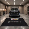 Cadillac garage floor mat, 5x7 ft (60x87"), full-color Cadillac crest shield and script wordmark on black background with dimensions shown.