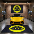 Large Lotus Cars logo floor rug, 5x7 ft (approx. 150x220cm), featuring the yellow and green crest, displayed in a modern minimalist garage.