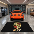 Porsche 911 garage floor mat, 5x7 ft (60x87"), full Porsche crest shield and gold 911 script numerals on black background with dimensions shown.